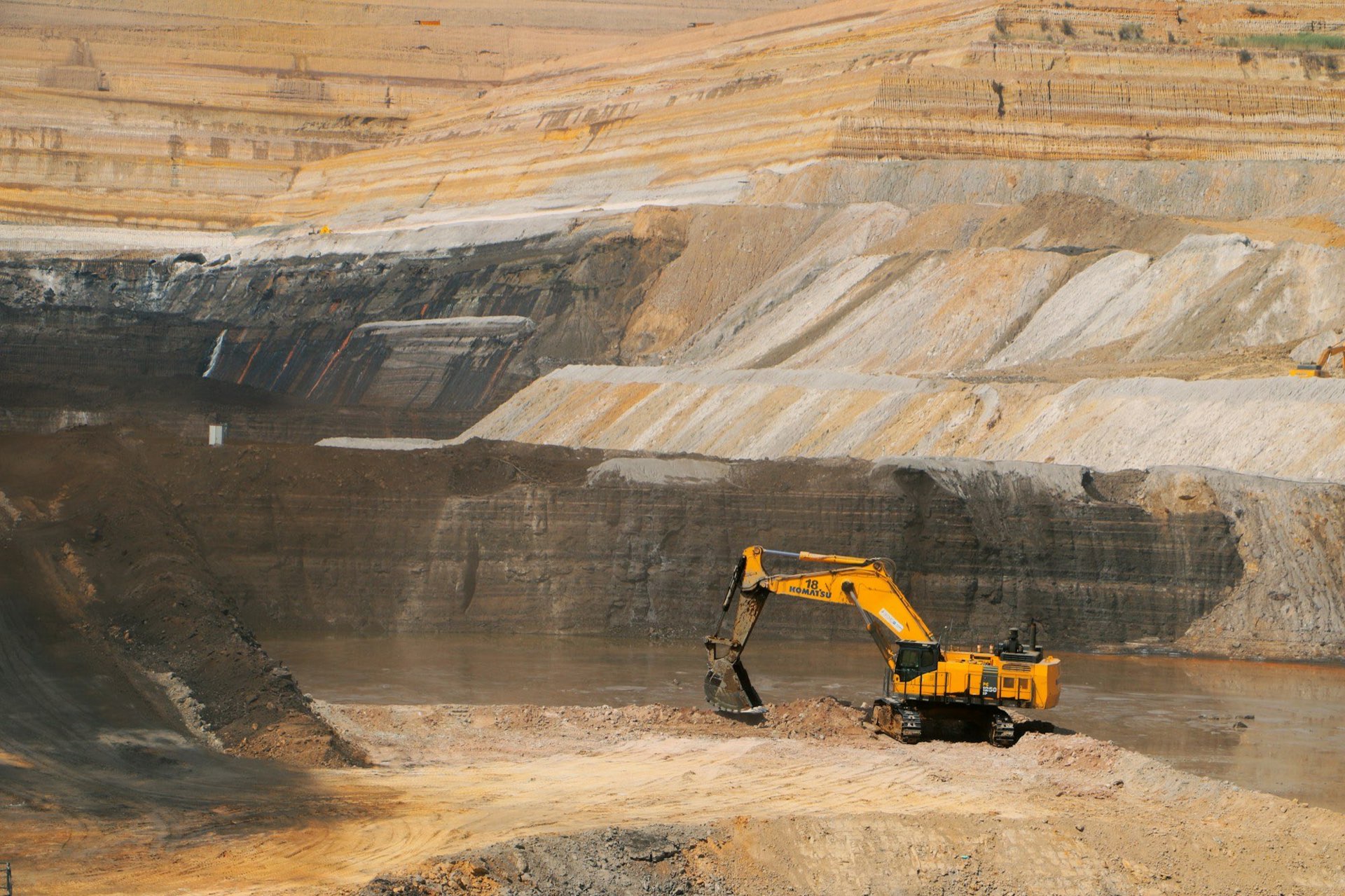 Excavator working on the benches of an open-pit operation
